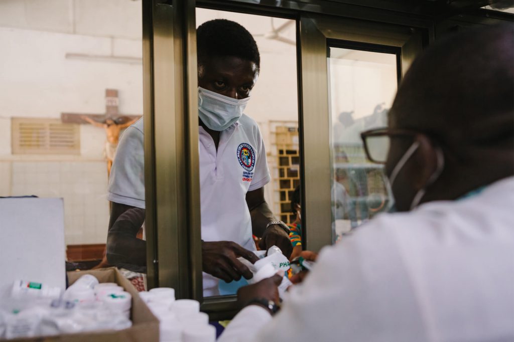 Joseph picks up ART medications to deliver to the people he counsels through the Model of Hope program.
